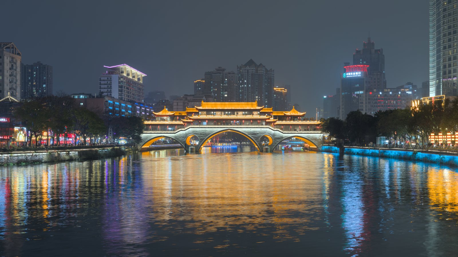 Anshun Bridge lit up over the Jin River at night in Chengdu.
