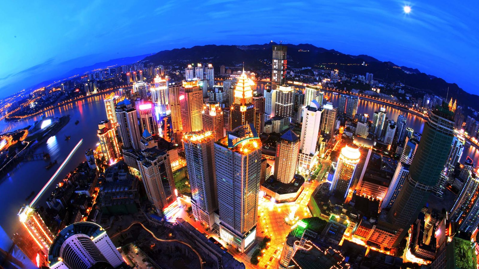 A dazzling aerial night view of Chongqing's Yuzhong skyline and rivers like the panorama travelers seek from Yikeshu.