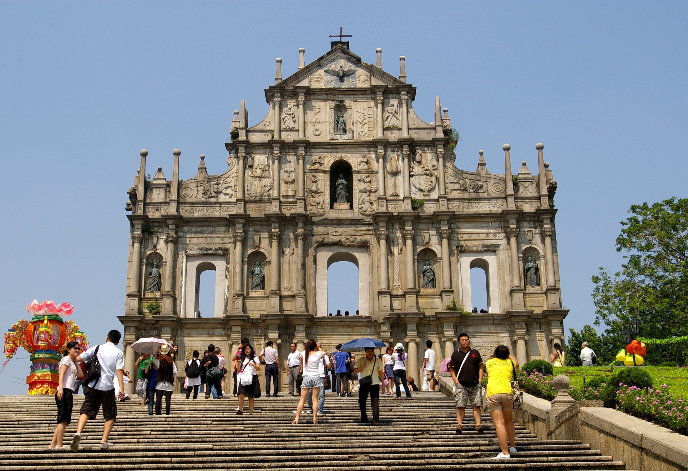 The Ruins of St. Paul's facade in Macau rising above the stone steps on a bright day.