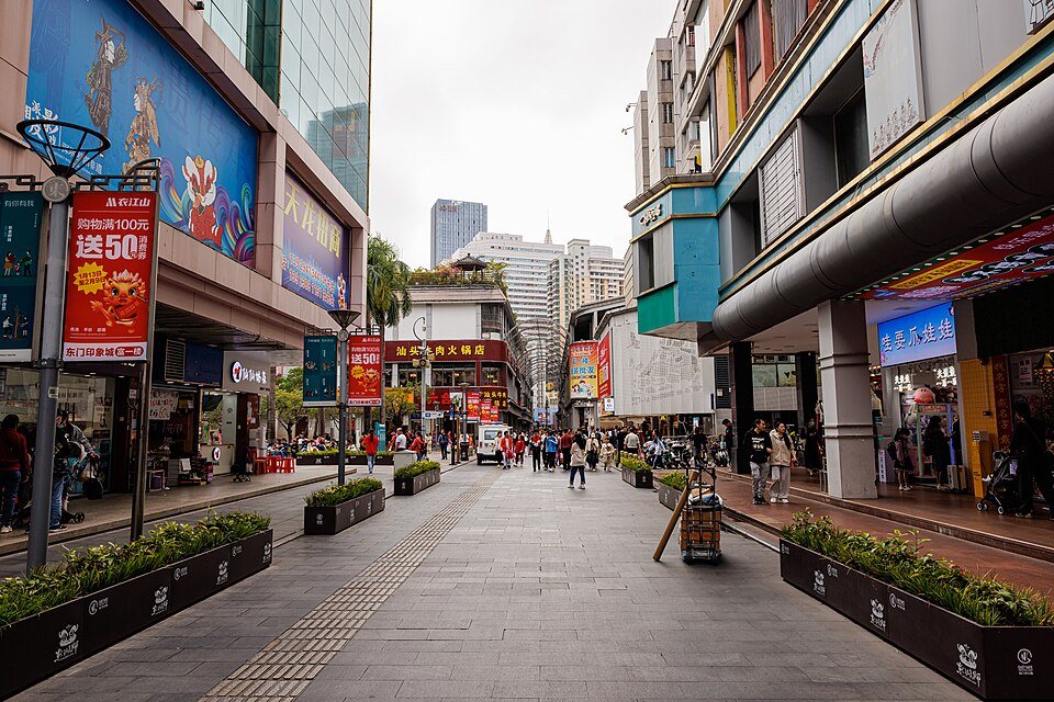A bright pedestrian street scene in Shenzhen's Dongmen Old Street area.
