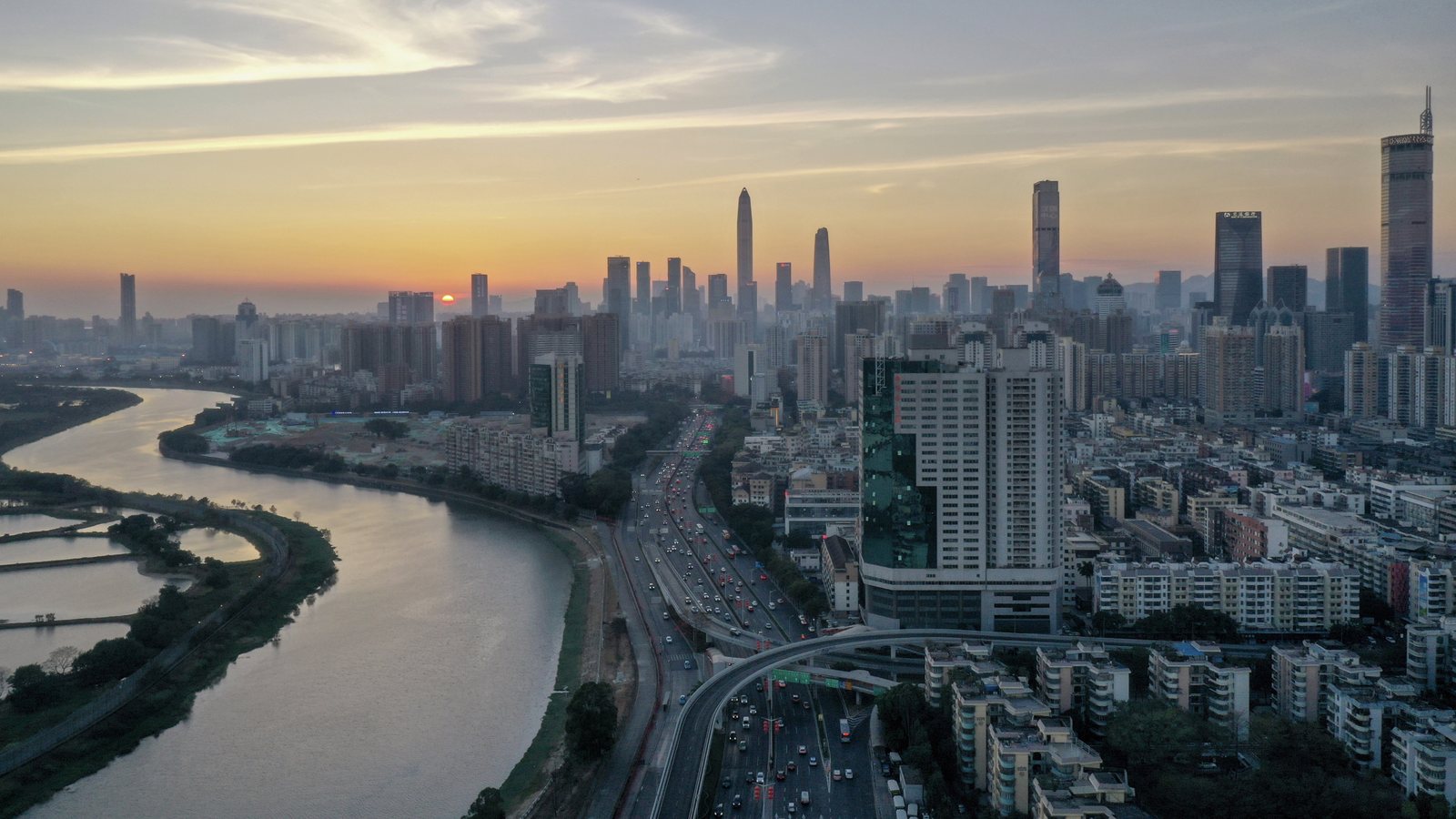 Sunset skyline view over Shenzhen Bay and the Nanshan side of the city.