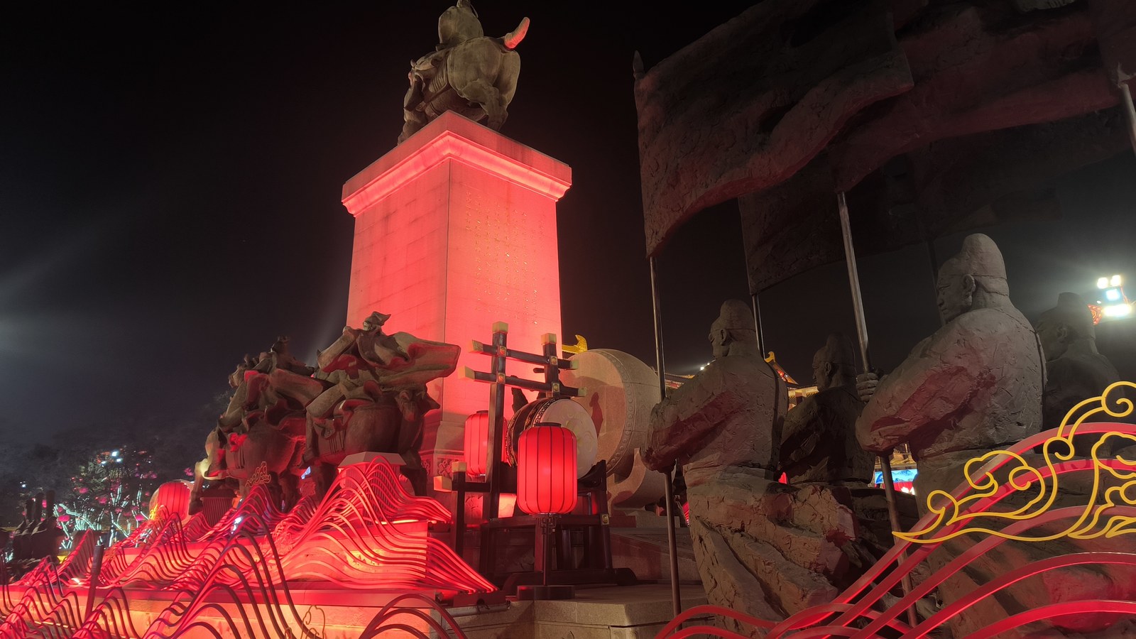 Illuminated Tang-style sculptures and red lanterns at Great Tang All Day Mall in Xi'an at night.