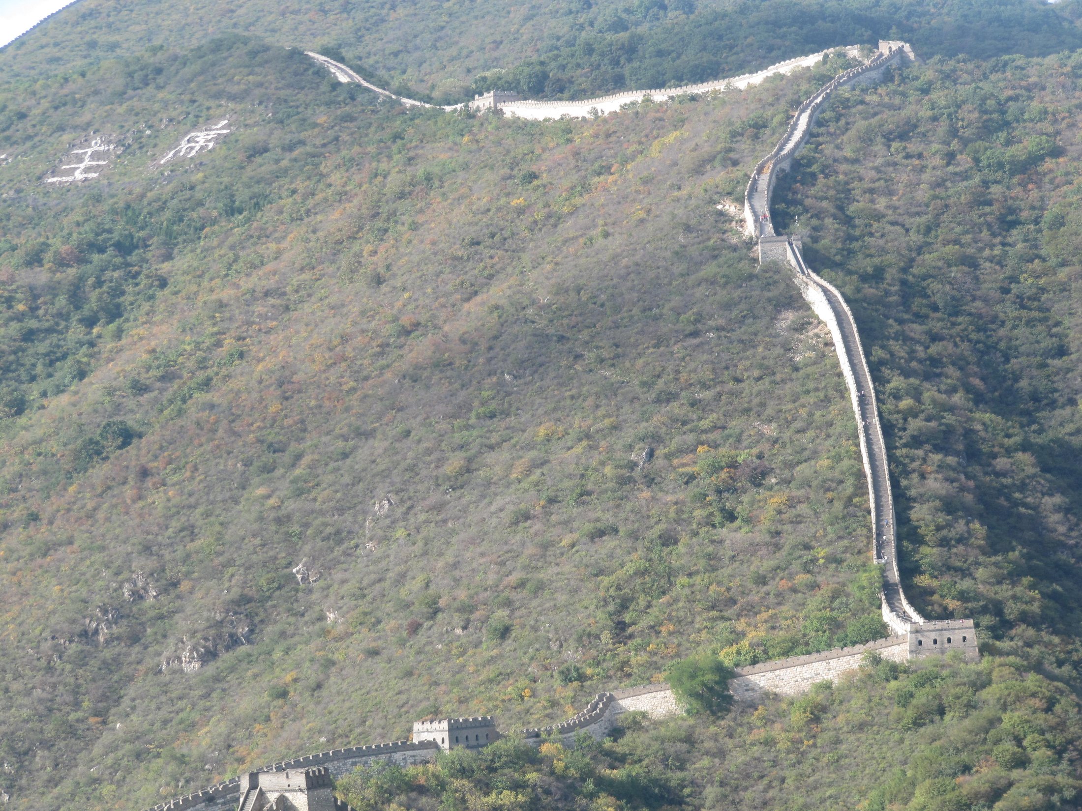 The Badaling section of the Great Wall winding across mountain ridges under clear daylight.