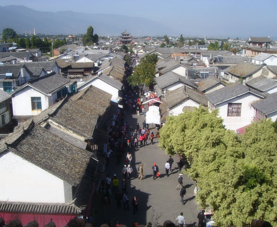 Dali Old Town under broad Yunnan light, where white walls and tiled roofs open onto a basin that feels spacious rather than theatrical.