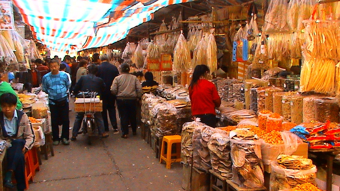 Bo'ai Road in Haikou, where older shopfront rhythms still survive beneath the subtropical haze.