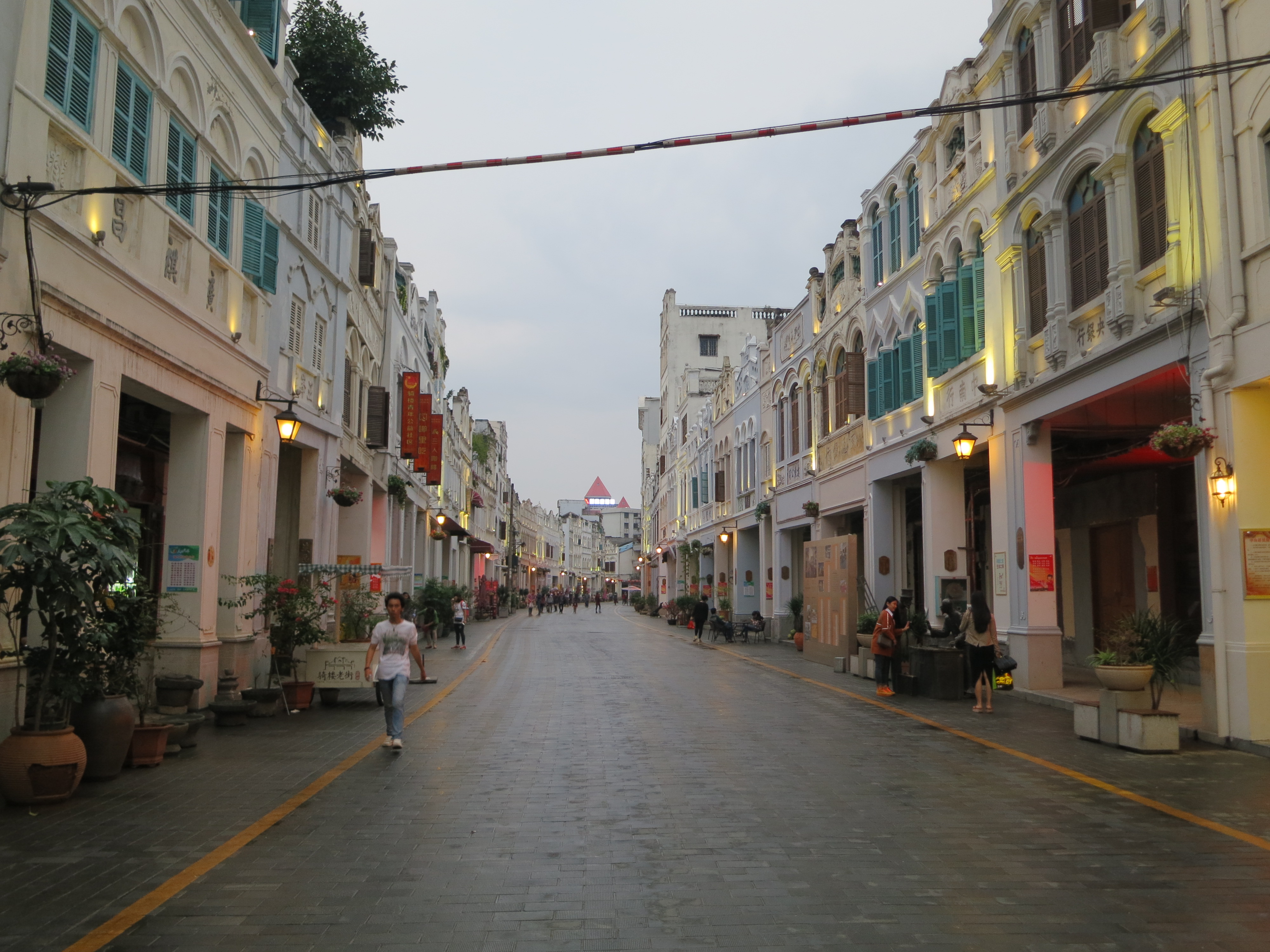 Historic arcaded street architecture in Haikou's Qilou district under bright subtropical daylight.
