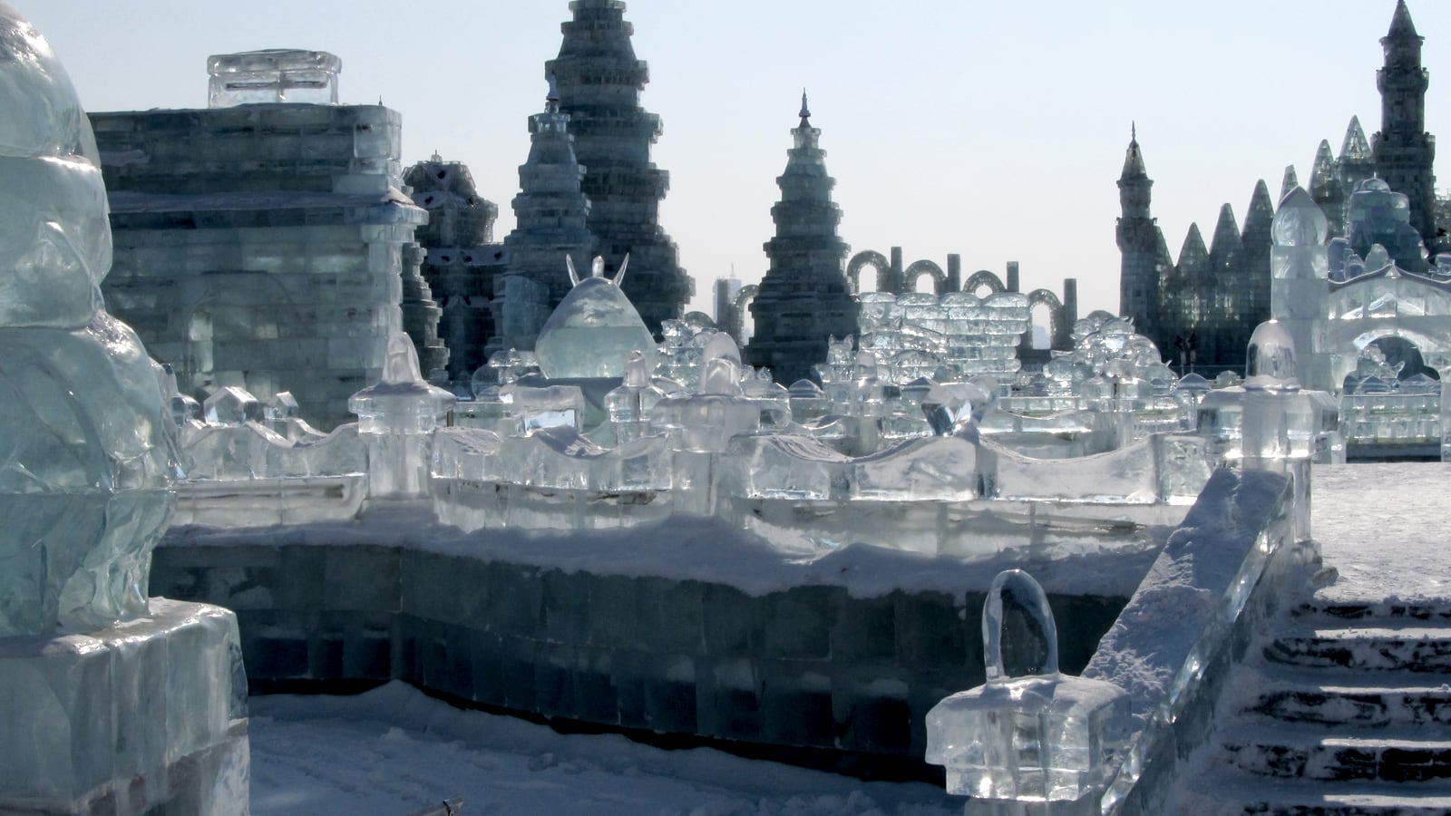 Ice architecture glowing in winter darkness at Harbin's great seasonal spectacle.