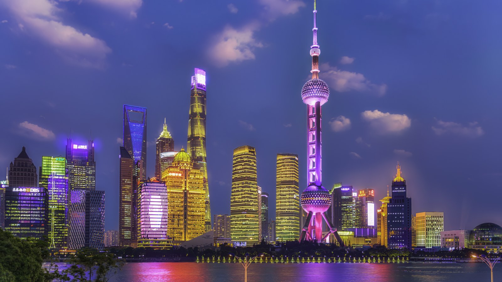 Shanghai skyline at night seen from the North Bund with the Oriental Pearl Tower and Pudong towers illuminated.