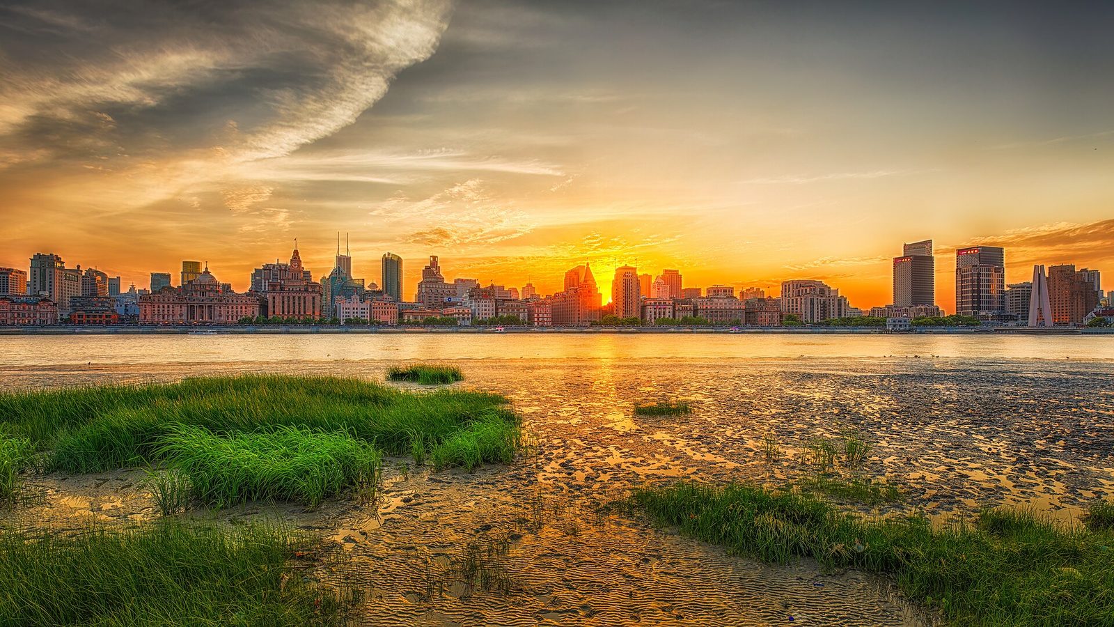 Sunset over the Bund in Shanghai with skyline glow across the river.
