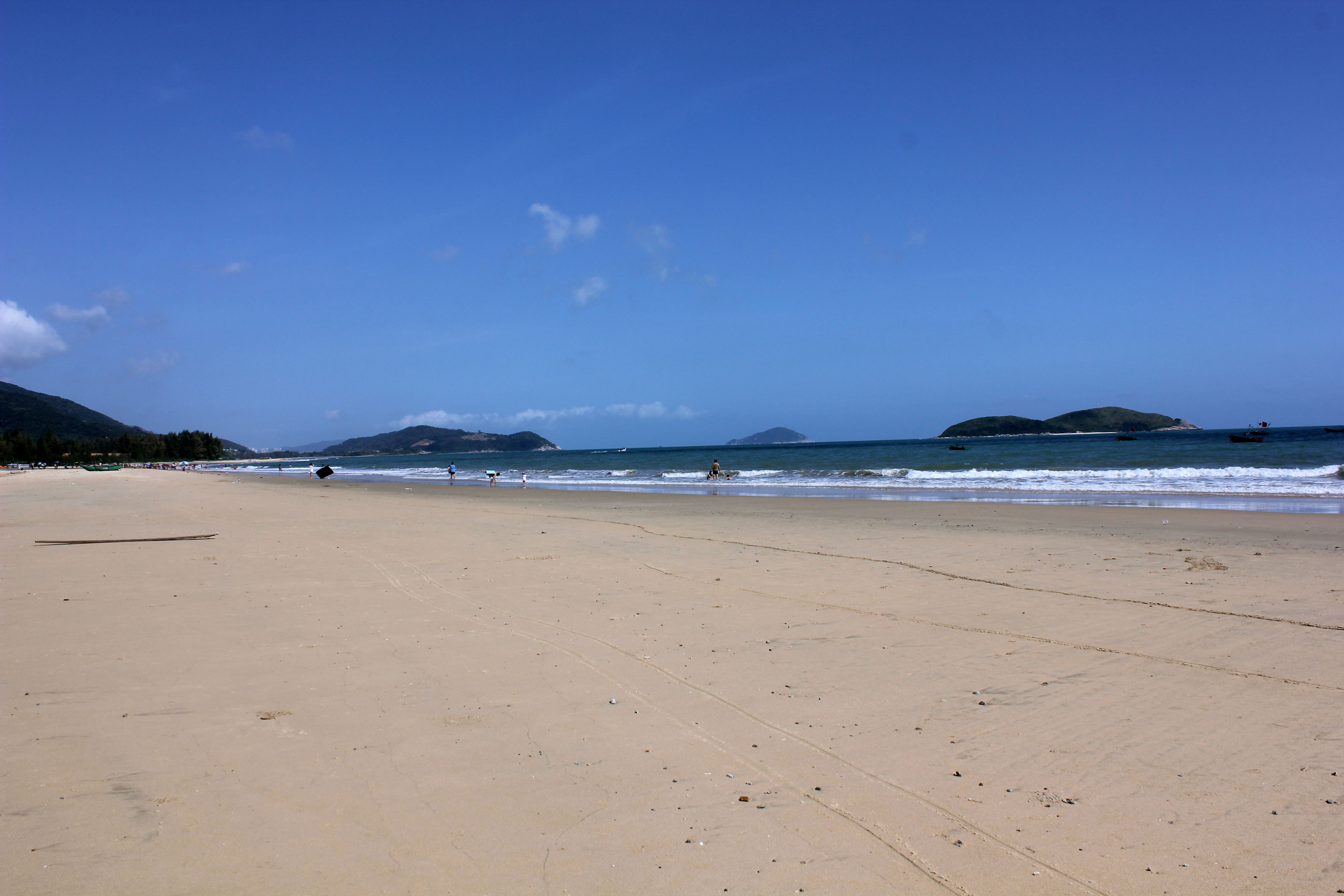 Shimei Bay in Wanning, where the sea widens, the buildings fall back, and east-coast Hainan begins to feel almost shy.